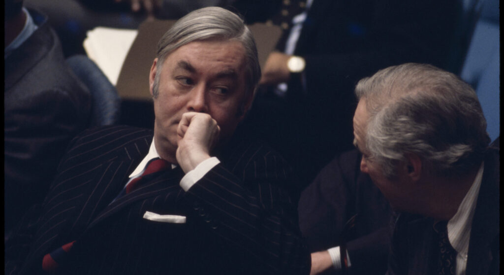 Ambassador Daniel Patrick Moynihan seated in the United Nations Security Council listening to the debates on the Middle East (1976) 