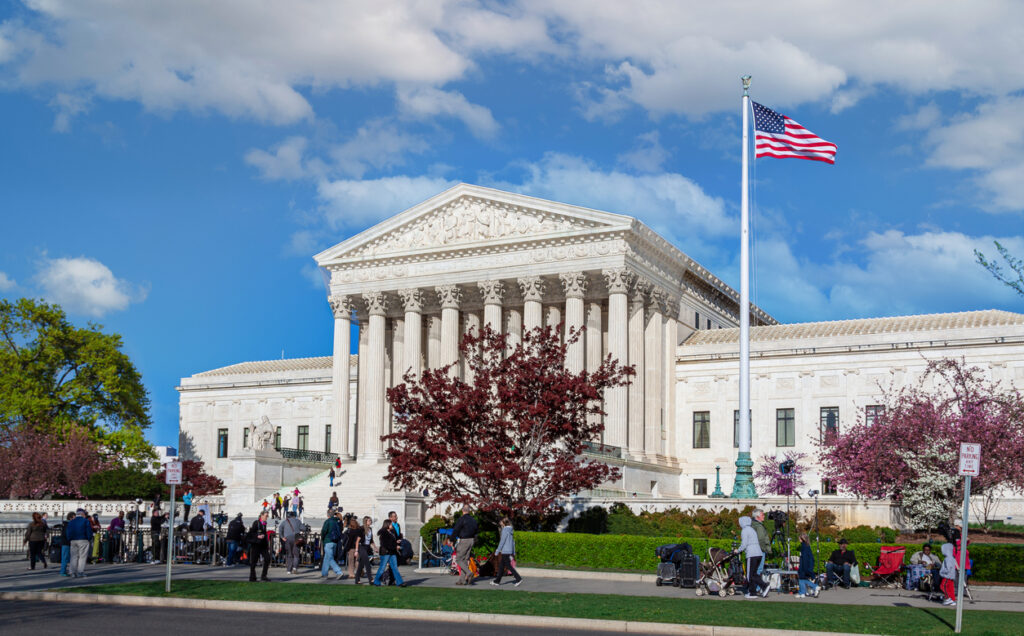 U.S. Supreme Court Building with Activists, the Press and Sightseeing Tourists in Front of the Court, Washington DC. 