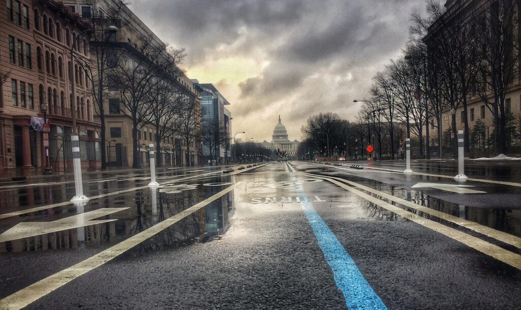 In the morning before an Inauguration, Pennsylvania Ave damp with rain shows the blue line of the parade route from the United States Capitol Building, in Washington DC.