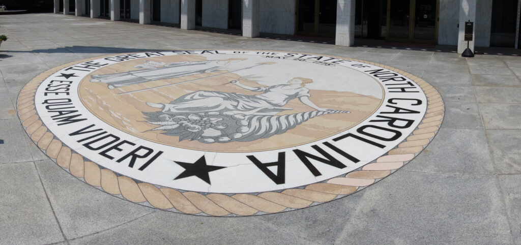 The front entrace of the North Carolina State Legislature building in Raleigh with the state seal and motto - Esse Quam Videri -- To Be, Rather Than To Seem