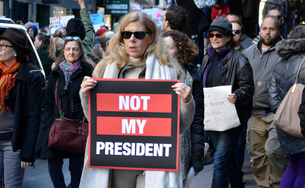 New York, New York - November 12, 2016: Protester carrying a sign while marching in a 