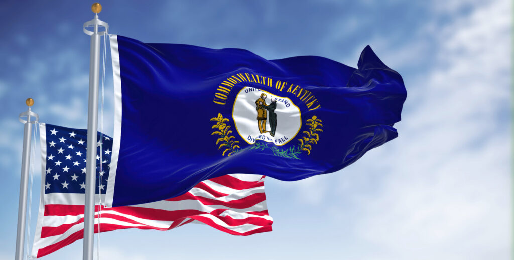The Kentucky state flag waving along with the flag of the U.S.A.